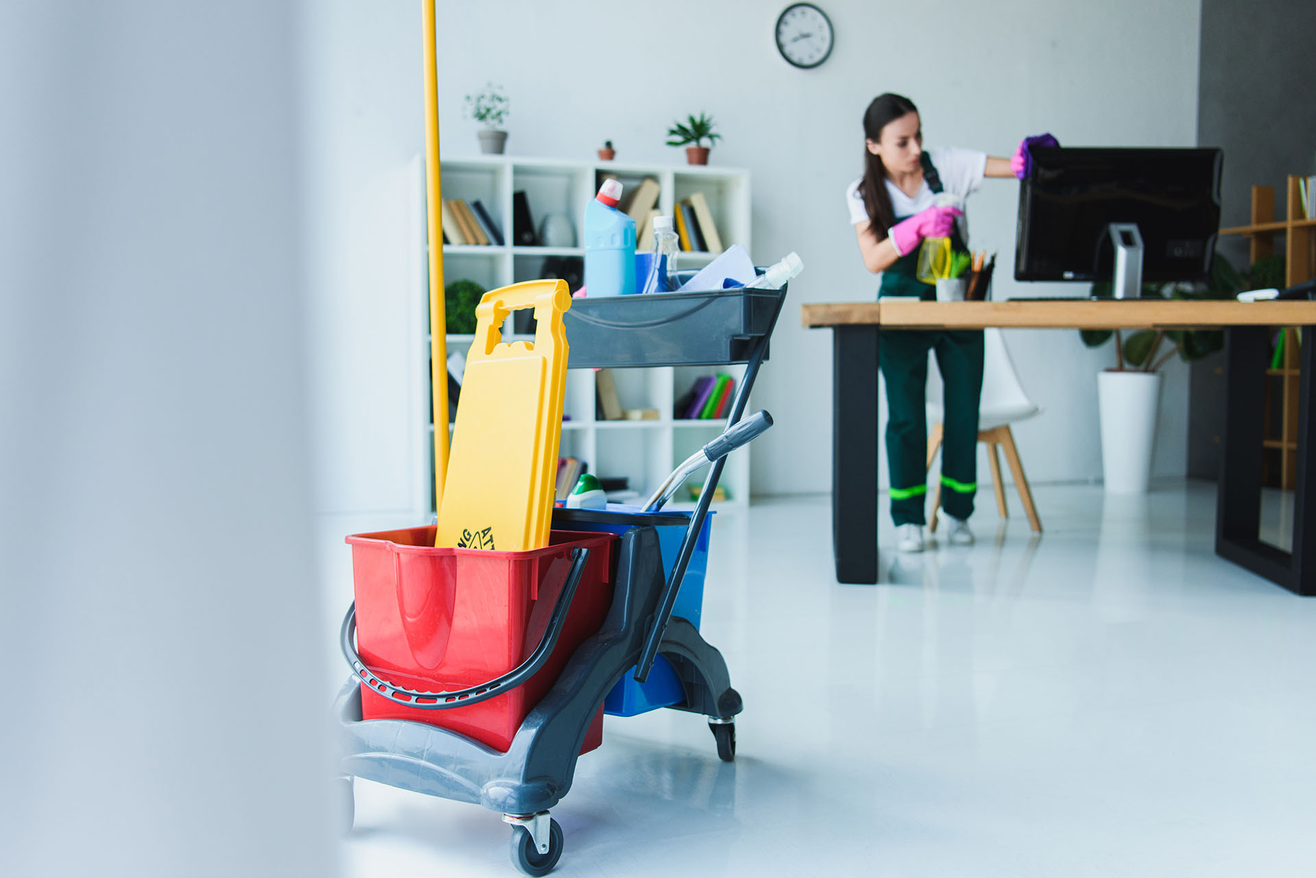young-female-janitor-cleaning-office-with-various-2021-08-29-22-36-48-utc.jpg